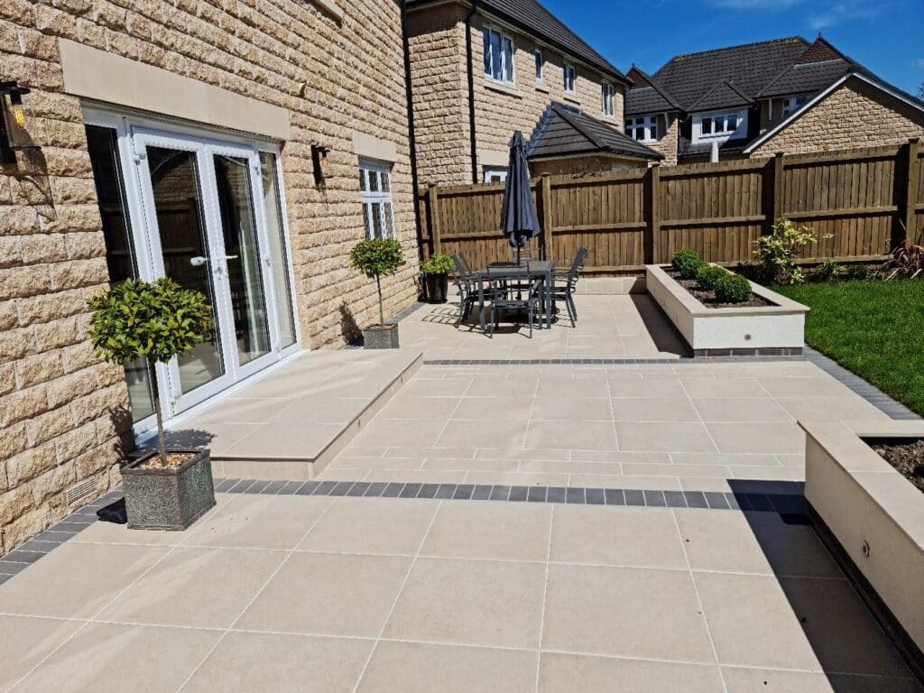 A modern patio design featuring elegant stone tiles and stylish planters.